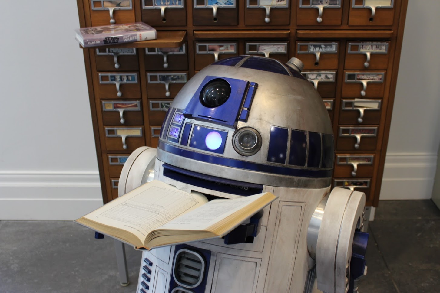 R2D2 reading a library book
