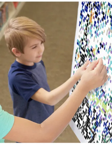 photo of child placing stickers on a mosaic art project