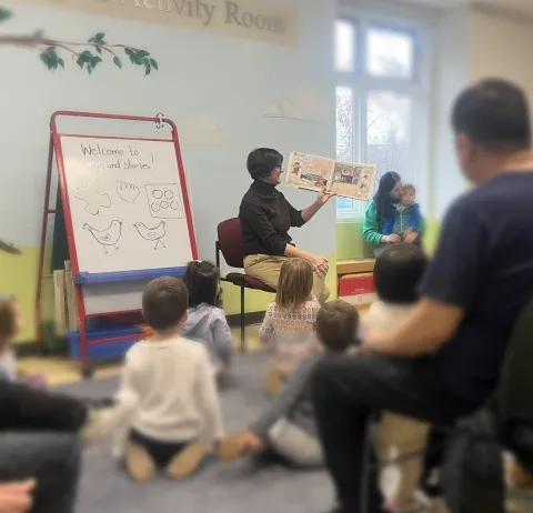 Photo of reader to group of kids