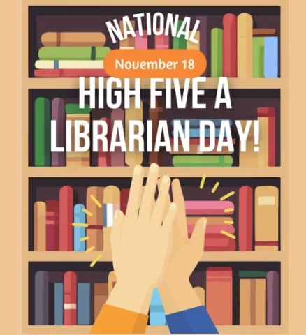two hands high fiving in front of book shelves