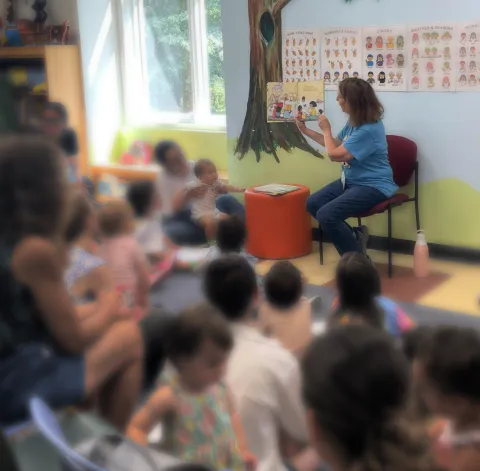Miss Elizzie reading to group