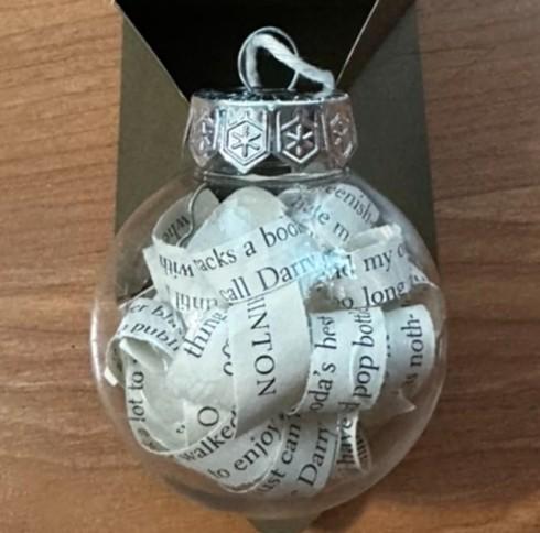 Clear Christmas tree ornament with strips of book pages filling the inside