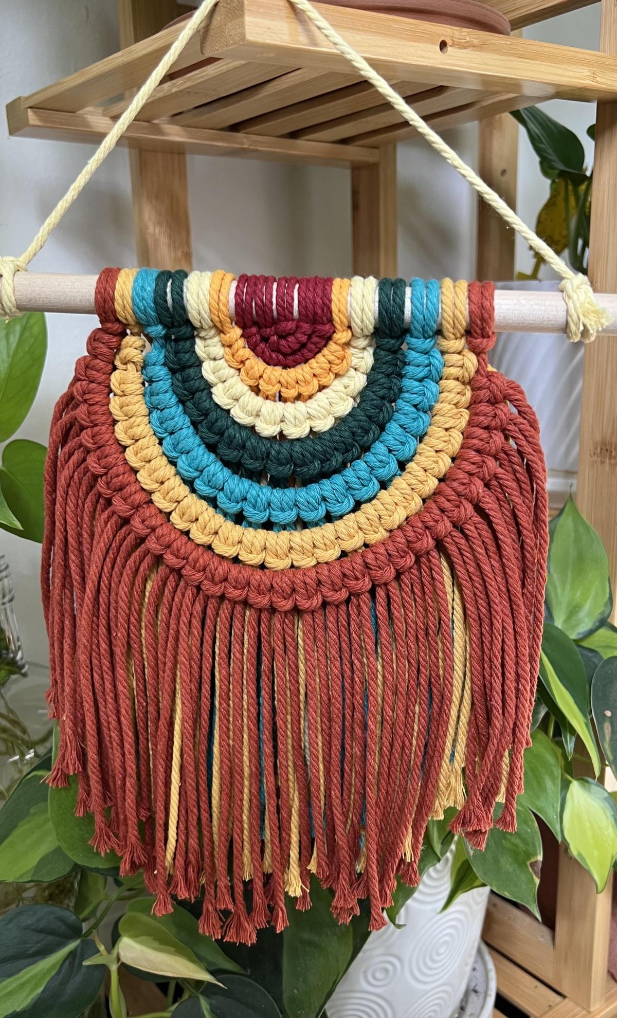 Image of a macrame wall hanging in bright colors