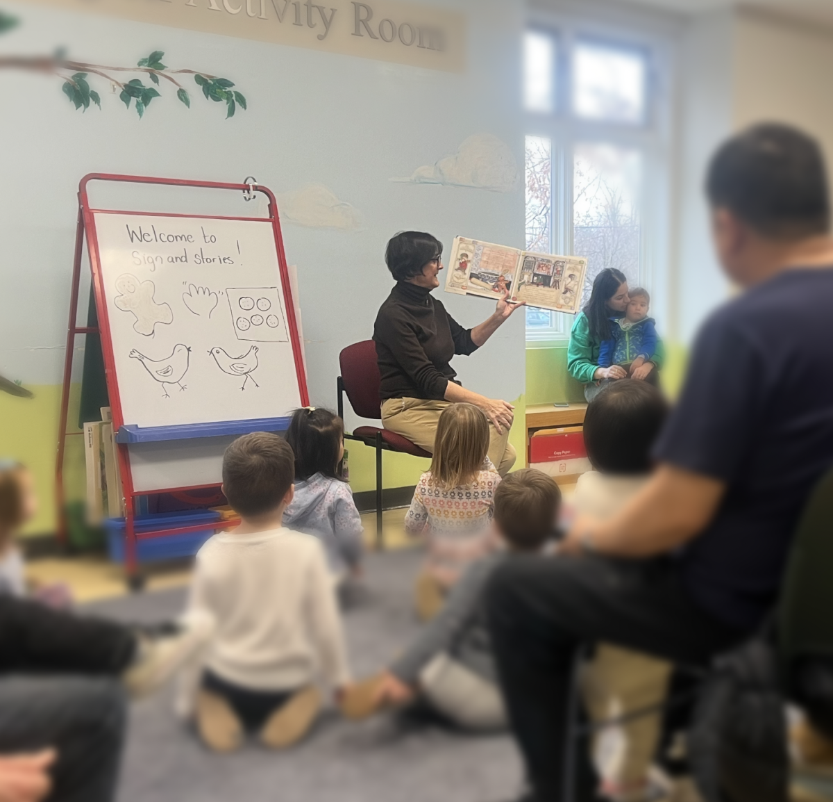 Miss Cathy reading; kids blurred